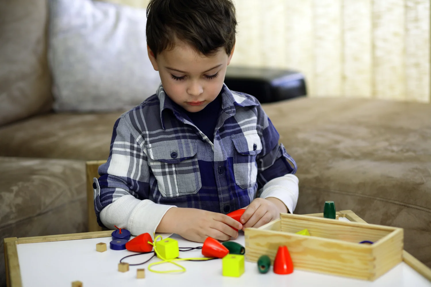 Young child arranging colorful wooden blocks