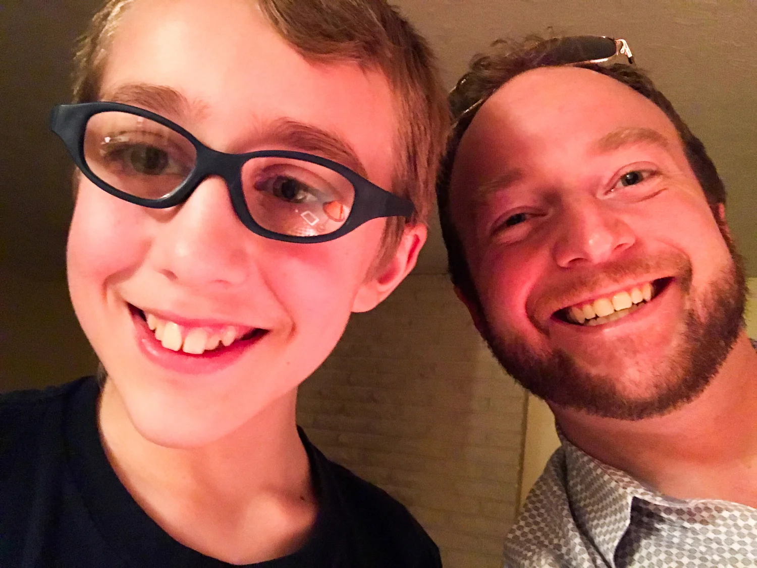 Young person and an adult smiling together for a selfie