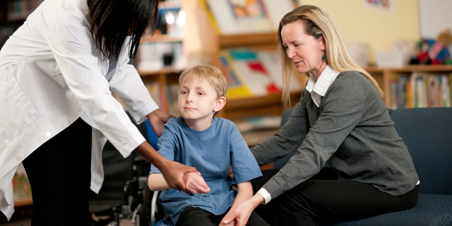 Therapist and parent helping a young child during a session
